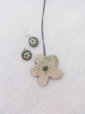 Floral Terracotta necklace and earrings on a textured white background