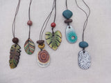 Set of colorful Terracotta necklaces on a light background