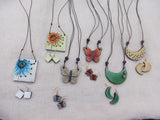 Collection of colorful Terracotta necklaces and earrings on a light background