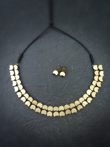 Gold  terracotta necklace and earrings on a dark surface