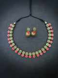 Terracotta Necklace and earrings set with green and red accents on a dark background