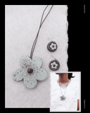 Floral Terracotta  pendant necklace on a textured white background