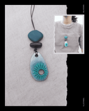 Turquoise Terracotta pendant necklace on a textured gray background with a person wearing the necklace inset.